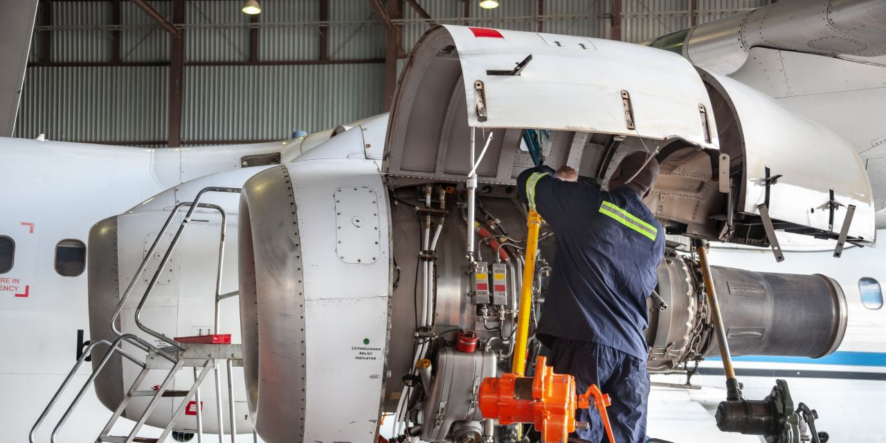 Man fixing an airplane engine