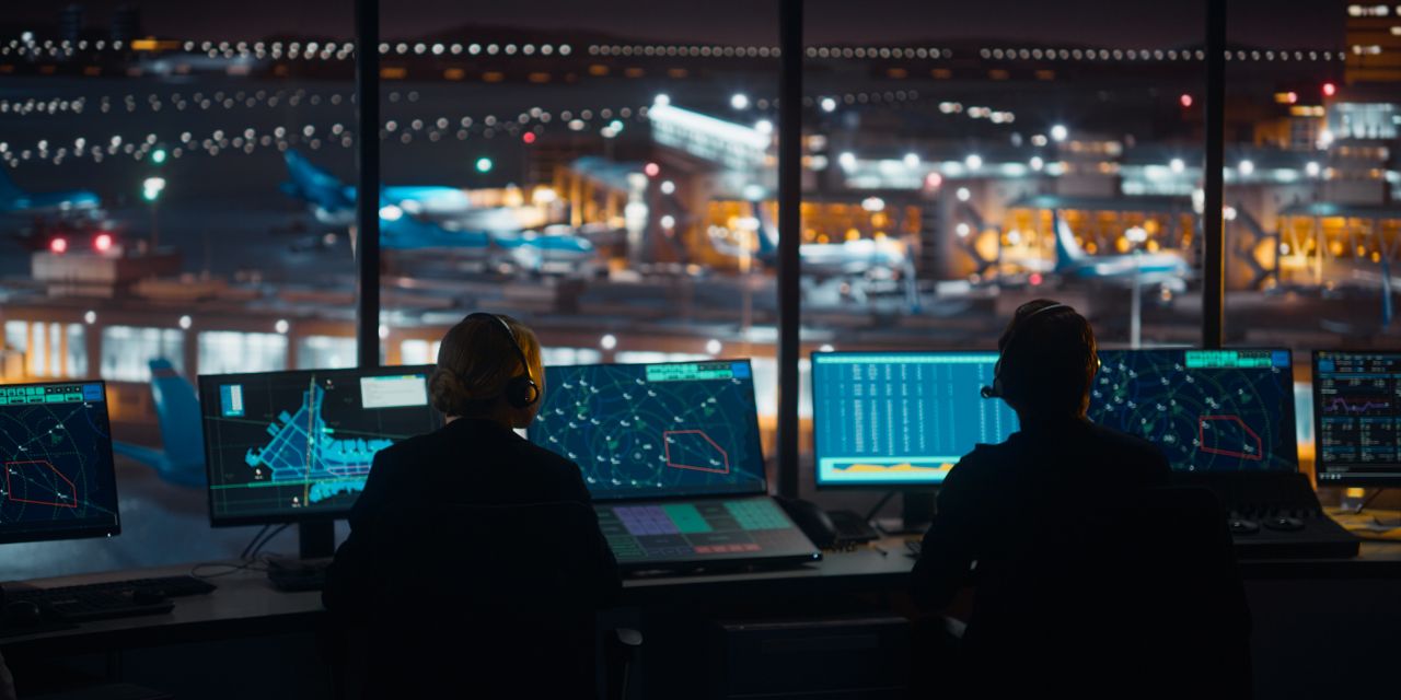 Air traffic control officers looking at a screen