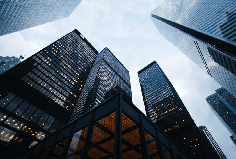 Looking up into the sky in a city, showcasing tall buildings