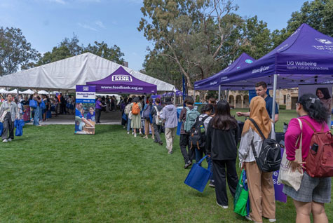 About 10 people standing in line at an Allianz Partners foodbank market stall line