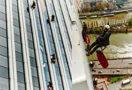 Technicians working hard to display the colours of Paris 2024 on Neptune Tower