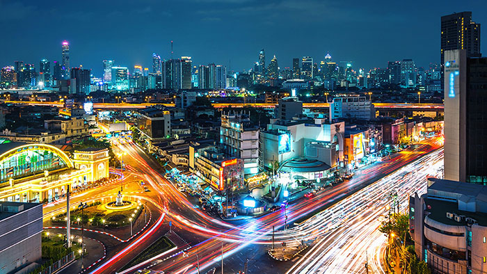 Nighttime cityscape with heavy traffic flow and modern mobility infrastructure.