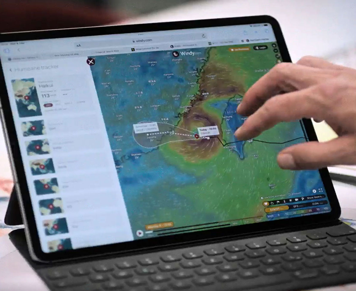 Weather radar on a monitor, with a hand pointing at it