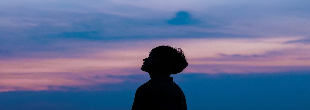 a man is looking up to the sky