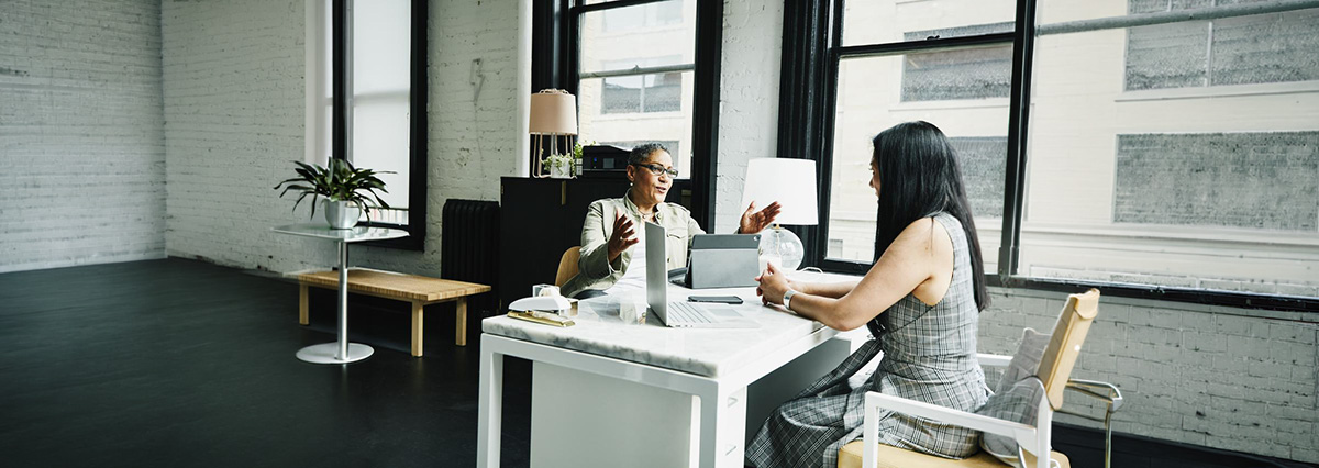 An image showing a couple of people discussing invoice factoring