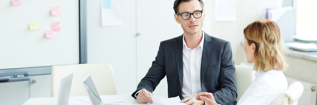 An image representing two people discussing what credit management is and its benefits