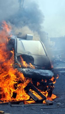 A car on fire from a terrorist attack