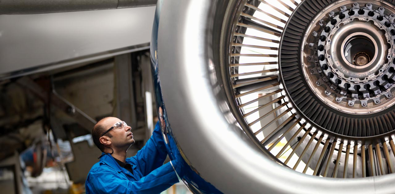 Aeronautical engineer inspects detail on an aircraft engine