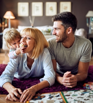 Imagen de una familia jugando en el salón de su casa